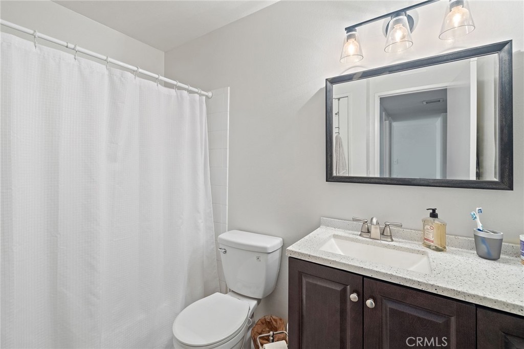 329 Surry Court Brea, CA 92821 - Photo 27 of 47 a bathroom with a granite countertop sink vanity mirror and toilet