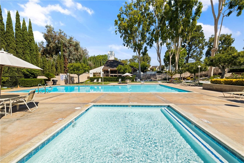 329 Surry Court Brea, CA 92821 - Photo 38 of 47 a view of a swimming pool with a bench and trees