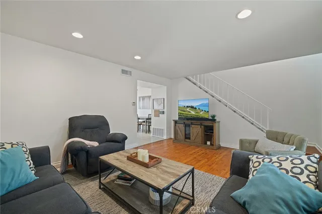 a living room with furniture and wooden floor