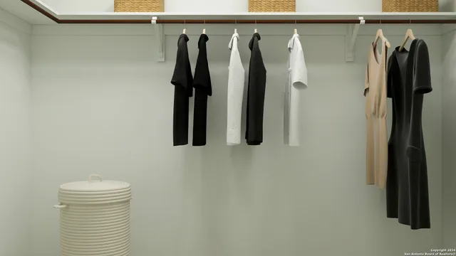 a view of walk in closet with clothes