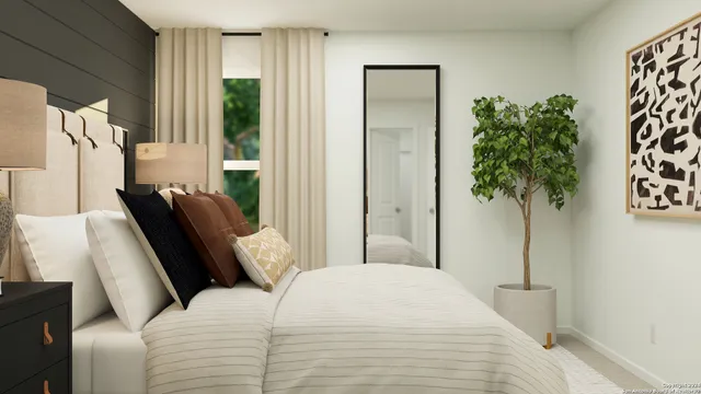 a bedroom with furniture and a potted plant
