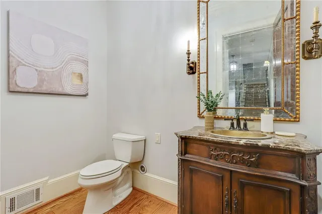 a bathroom with a stove a sink and a mirror