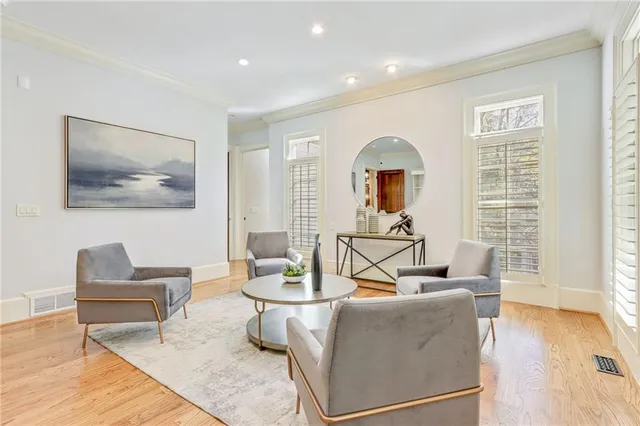 a living room with furniture and a wooden floor