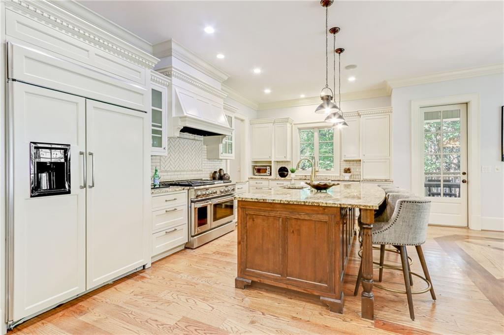 4227 Peachtree Dunwoody Road Atlanta, GA 30342 - Photo 17 of 44 a kitchen with granite countertop a sink appliances cabinets and furniture