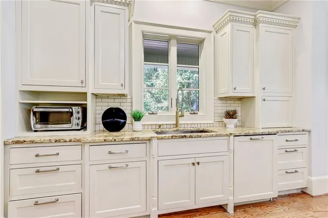 a kitchen with appliances cabinets and a window