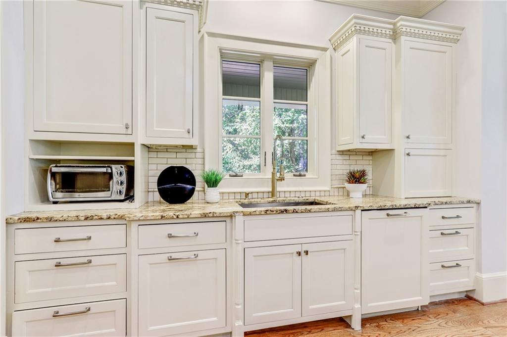 4227 Peachtree Dunwoody Road Atlanta, GA 30342 - Photo 19 of 44 a kitchen with appliances cabinets and a window
