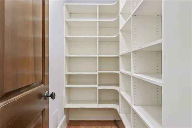 a view of walk in closet with empty racks