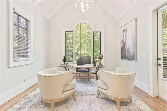 a living room with furniture a table and a large window
