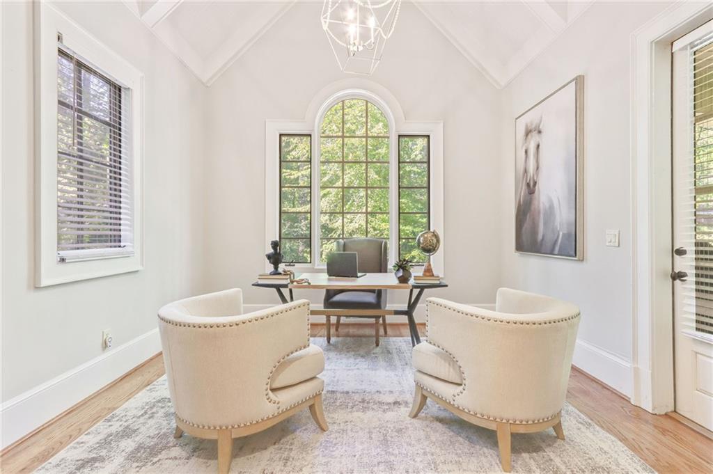 4227 Peachtree Dunwoody Road Atlanta, GA 30342 - Photo 24 of 44 a living room with furniture a table and a large window