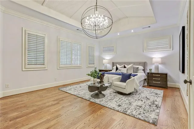 a living room with furniture a chandelier and a table