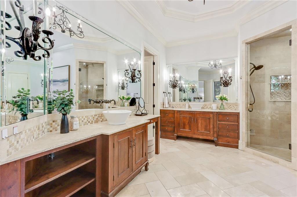 4227 Peachtree Dunwoody Road Atlanta, GA 30342 - Photo 27 of 44 a bathroom with a granite countertop double vanity sink mirror and shower