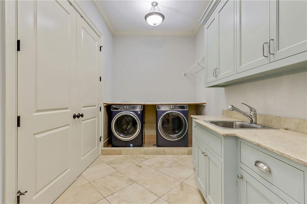 4227 Peachtree Dunwoody Road Atlanta, GA 30342 - Photo 31 of 44 a utility room with sink dryer and washer