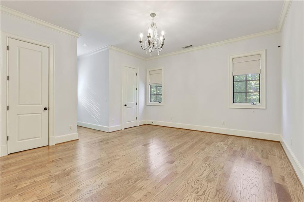 4227 Peachtree Dunwoody Road Atlanta, GA 30342 - Photo 34 of 44 a view of an empty room with wooden floor and a window