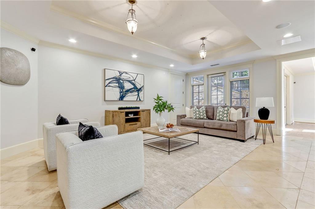 4227 Peachtree Dunwoody Road Atlanta, GA 30342 - Photo 37 of 44 a living room with fireplace furniture and a chandelier