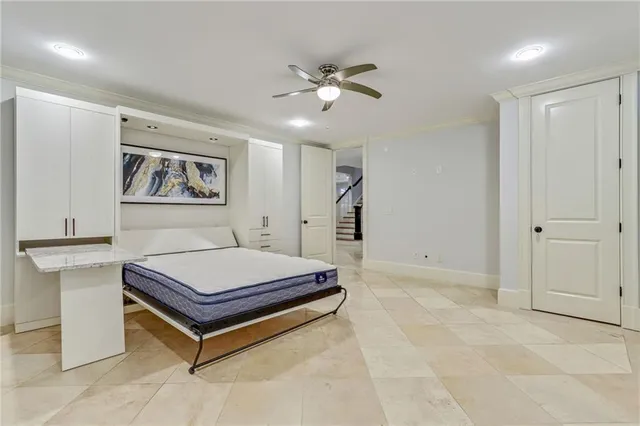 a room with pool table and paintings on the wall