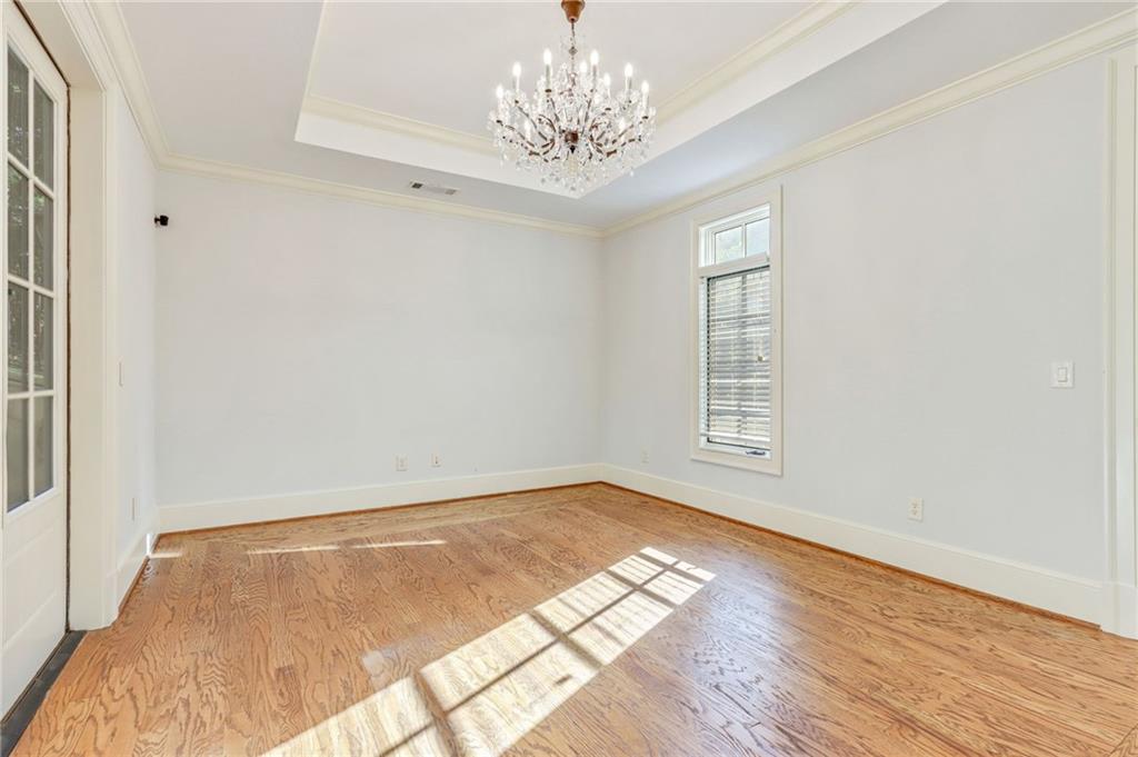 4227 Peachtree Dunwoody Road Atlanta, GA 30342 - Photo 40 of 44 a view of empty room with wooden floor and fan