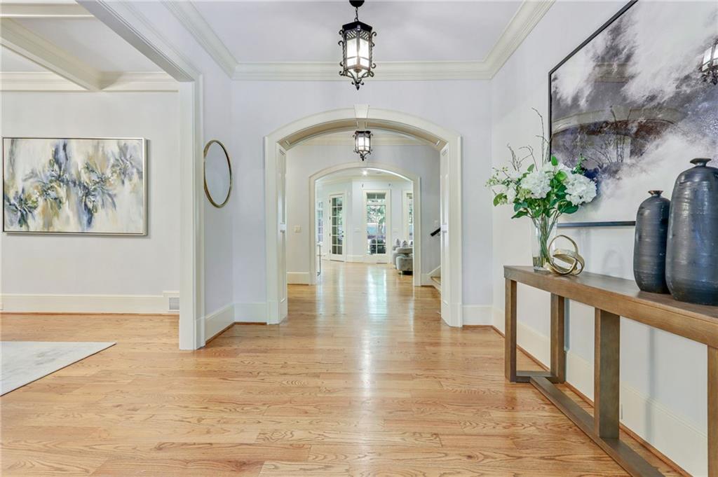 4227 Peachtree Dunwoody Road Atlanta, GA 30342 - Photo 5 of 44 a view of a hallway with wooden floor and a chandelier