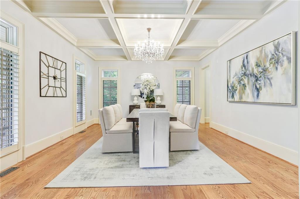 4227 Peachtree Dunwoody Road Atlanta, GA 30342 - Photo 6 of 44 a view of a dining room with furniture a chandelier and wooden floor