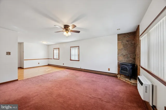 wooden floor in an empty room with a fireplace