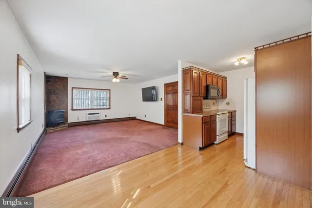 a view of kitchen with refrigerator and window