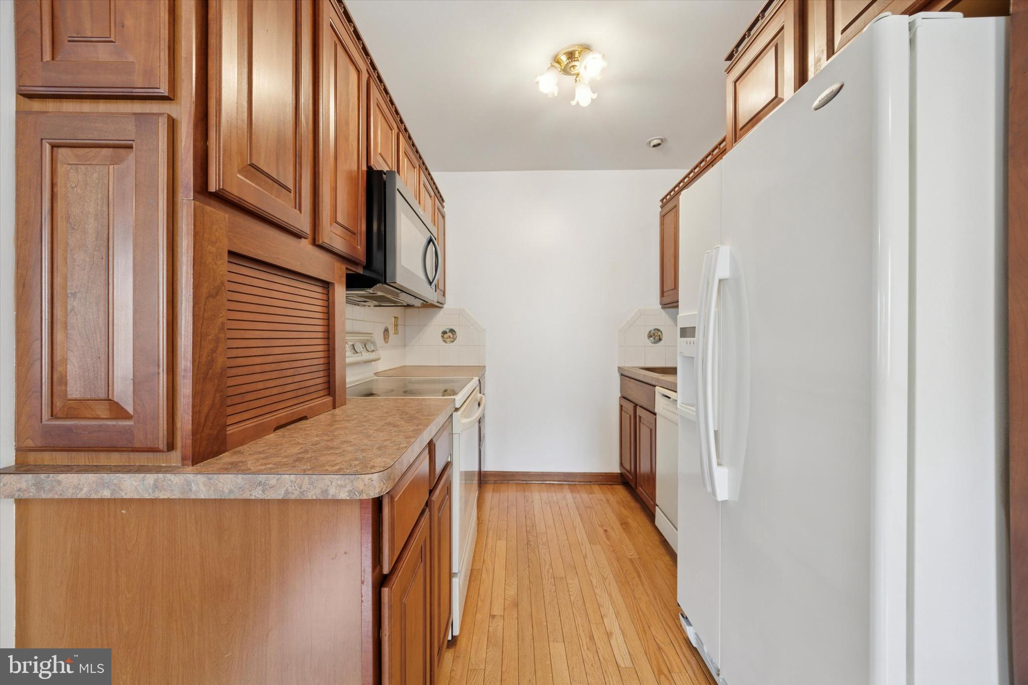 354 South Swarthmore Avenue, Unit B3 Swarthmore, PA 19081 - Photo 5 of 25 a kitchen view with wooden floor and electronic appliances