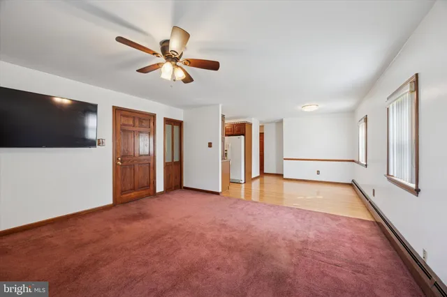 a view of a livingroom with a ceiling fan and window