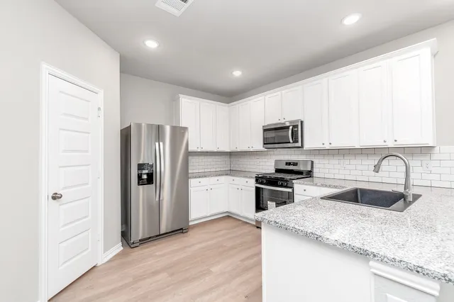 a kitchen with a stove microwave and refrigerator