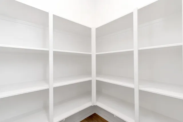 a kitchen with a sink dishwasher a stove and a refrigerator with wooden floor