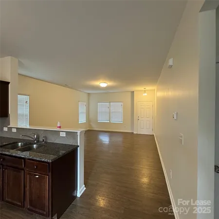 a kitchen with granite countertop a sink and a stove