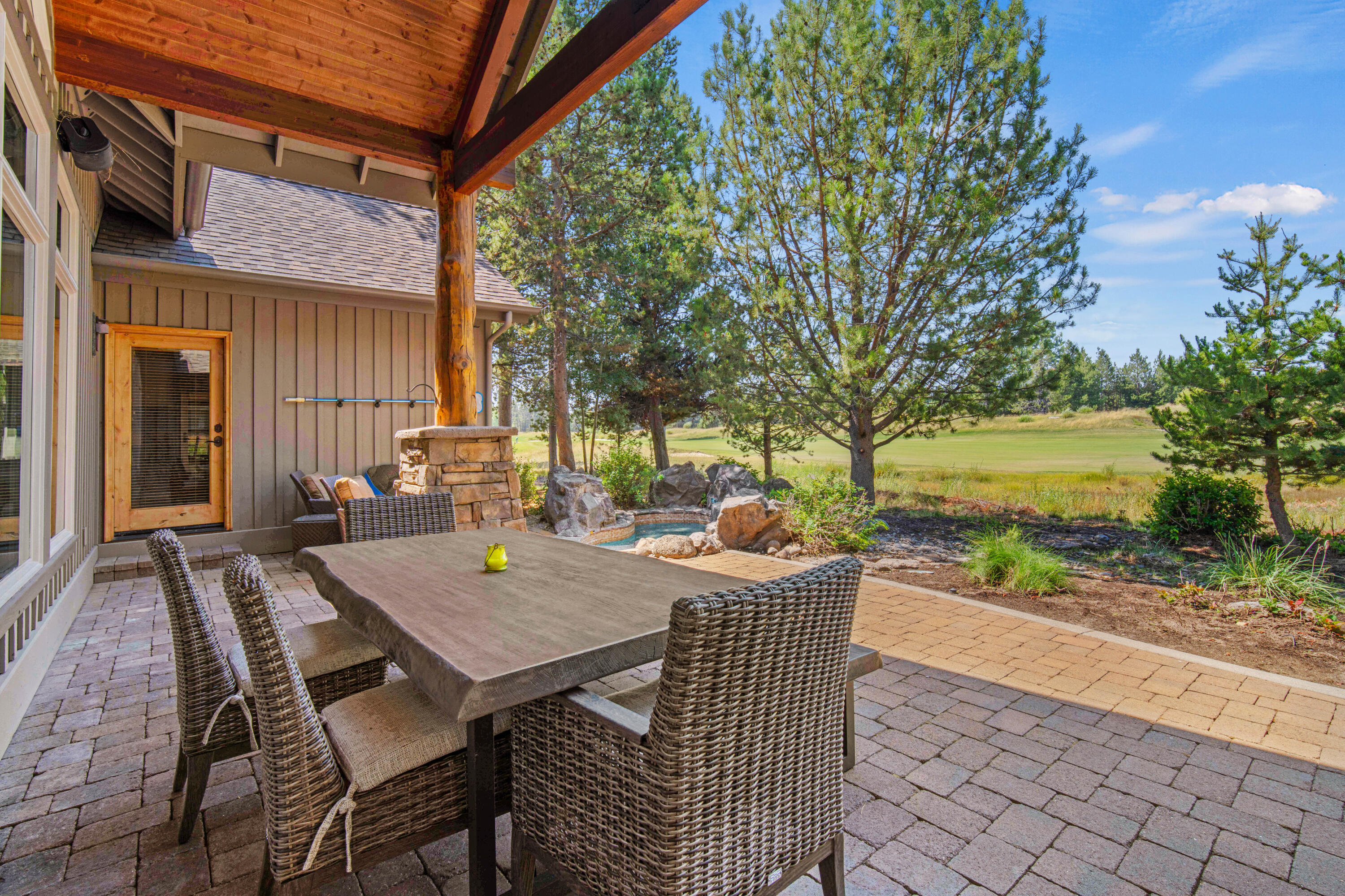 56689 Dancing Rock Loop Bend, OR 97707 - Photo 38 of 51 a view of a patio with a table and chairs next to yard