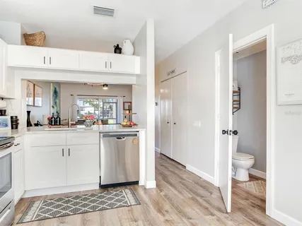 a spacious bathroom with a shower a sink and a mirror