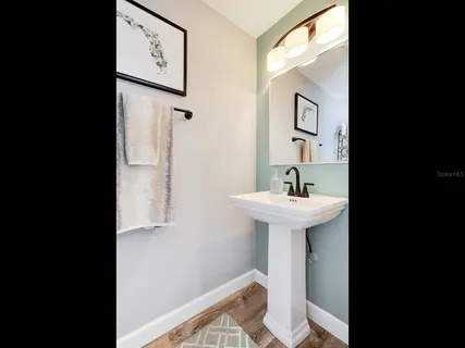 a bathroom with a sink a mirror and a toilet