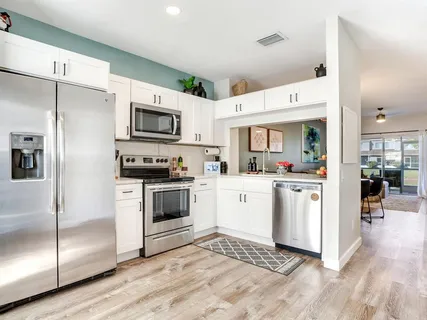 a kitchen with cabinets and stainless steel appliances