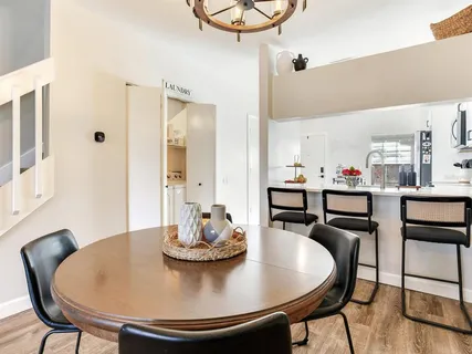 a dining room with furniture and wooden floor