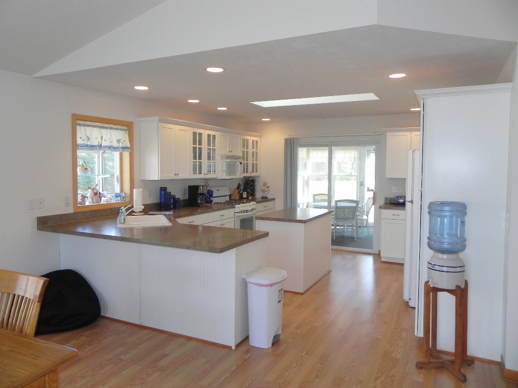 567 Baintree Road Lake Summerset, IL 61019 - Photo 11 of 25 a kitchen with stainless steel appliances granite countertop a refrigerator a sink a stove and white cabinets with wooden floor
