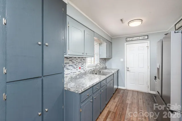 a kitchen with a sink stove and refrigerator