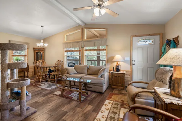 a living room with furniture and wooden floor