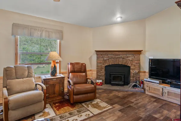 a living room with furniture a flat screen tv and a fireplace