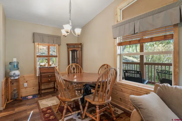 a dining room with furniture a chandelier and window