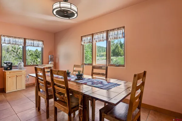 a view of a dining room with furniture window and outside view