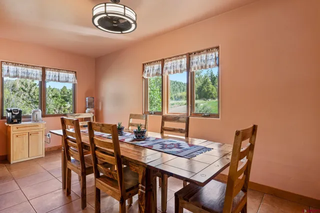 a view of a dining room with furniture window and outside view