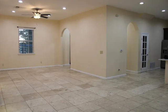 a view of a kitchen with furniture and a ceiling fan