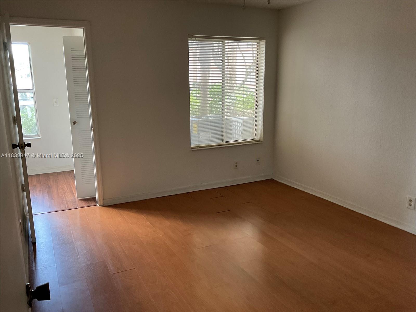 3320 Pinewalk Drive North, Unit 1715 Margate, FL 33063 - Photo 19 of 35 an empty room with windows