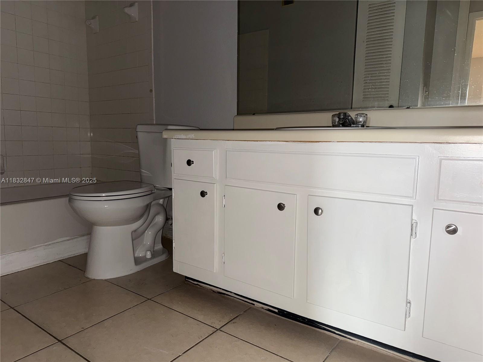 3320 Pinewalk Drive North, Unit 1715 Margate, FL 33063 - Photo 24 of 35 a bathroom with a toilet and a sink