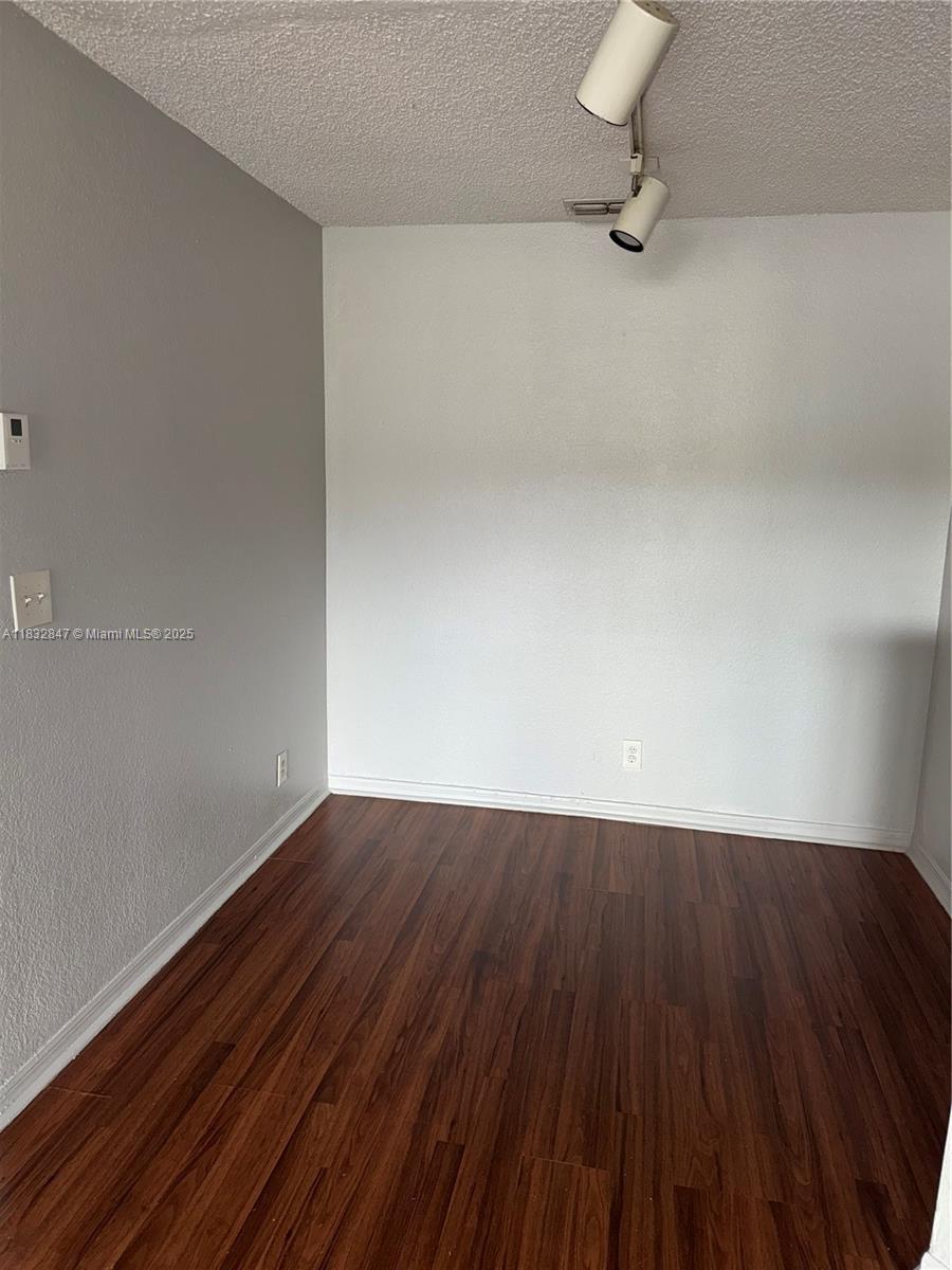 3320 Pinewalk Drive North, Unit 1715 Margate, FL 33063 - Photo 25 of 35 a view of a room with wooden floor