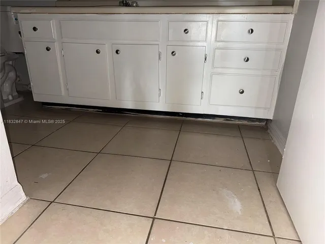 a living room with stainless steel appliances wooden floor
