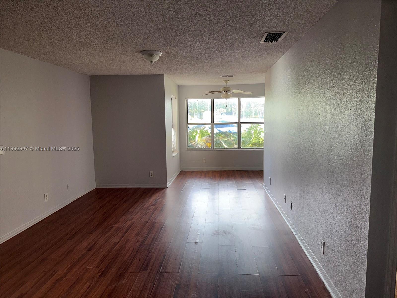3320 Pinewalk Drive North, Unit 1715 Margate, FL 33063 - Photo 28 of 35 wooden floor in an empty room with a window