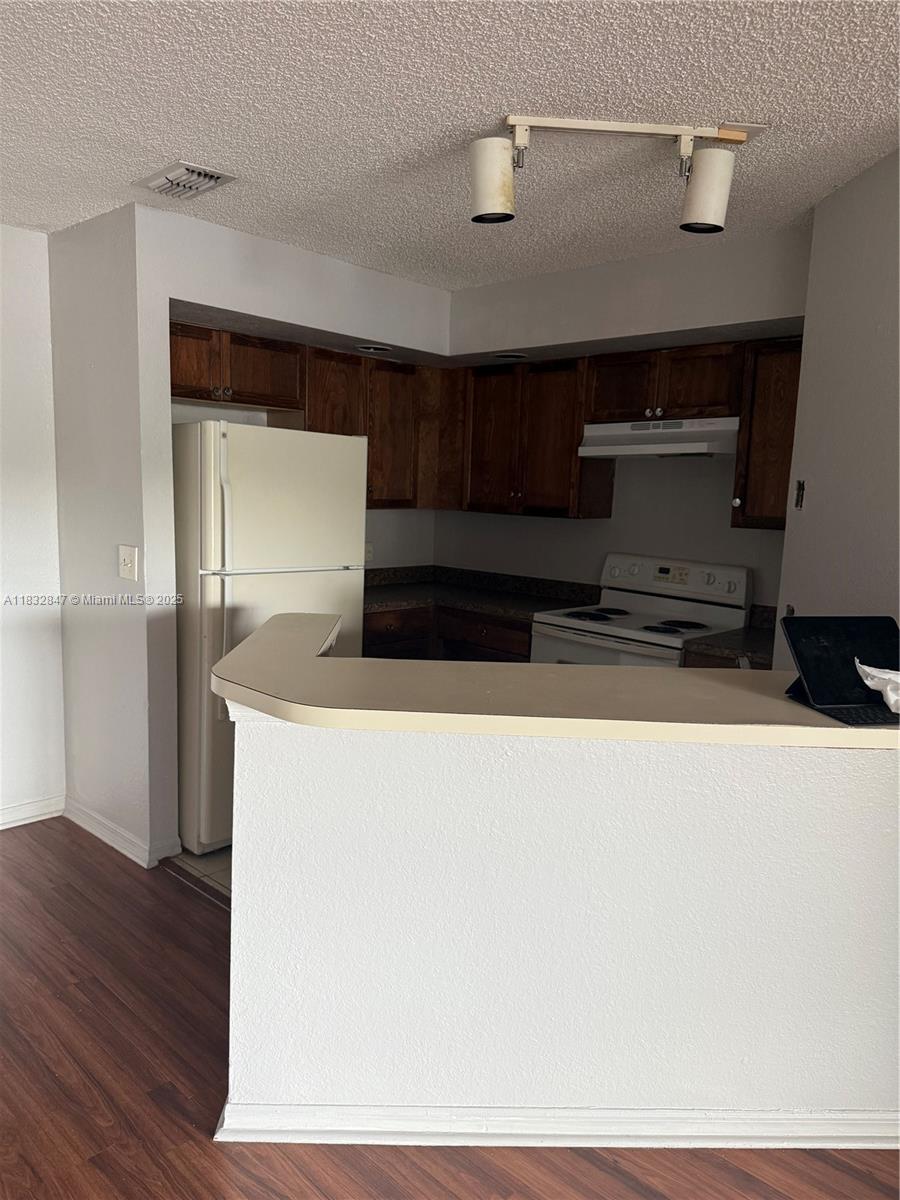 3320 Pinewalk Drive North, Unit 1715 Margate, FL 33063 - Photo 31 of 35 a living room with stainless steel appliances wooden floor