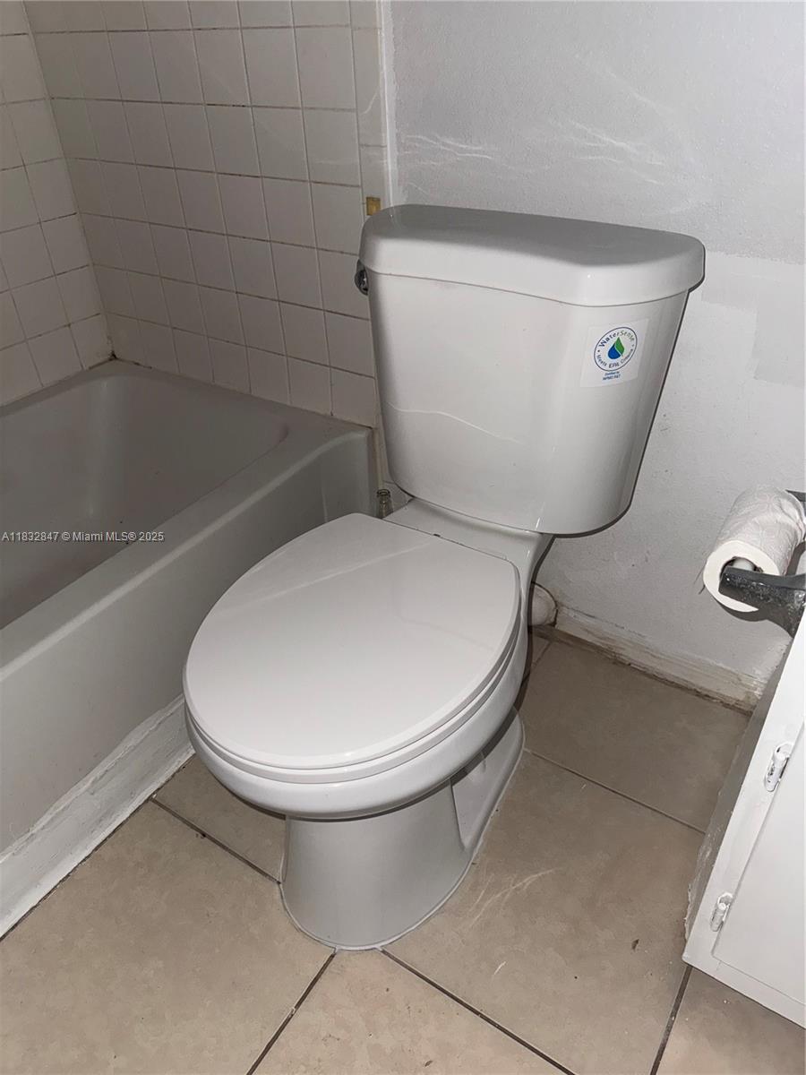 3320 Pinewalk Drive North, Unit 1715 Margate, FL 33063 - Photo 32 of 35 a bathroom with a toilet and a rug