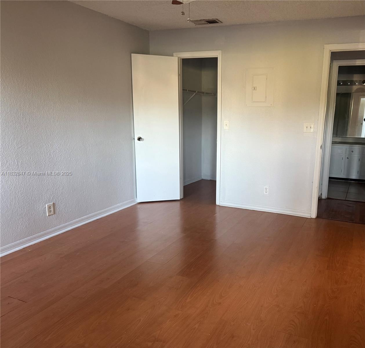 3320 Pinewalk Drive North, Unit 1715 Margate, FL 33063 - Photo 33 of 35 an empty room with wooden floor and a kitchen